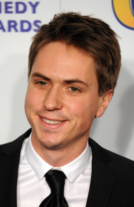 joe thomas in black suit on the red carpet of british comedy awards 